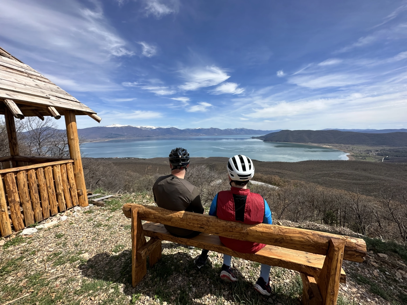 Two riders resting on a bench above Lake Ohrid, southeast Albania